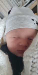 Baby Adam Gordon image shows his face and he is wearing a hat